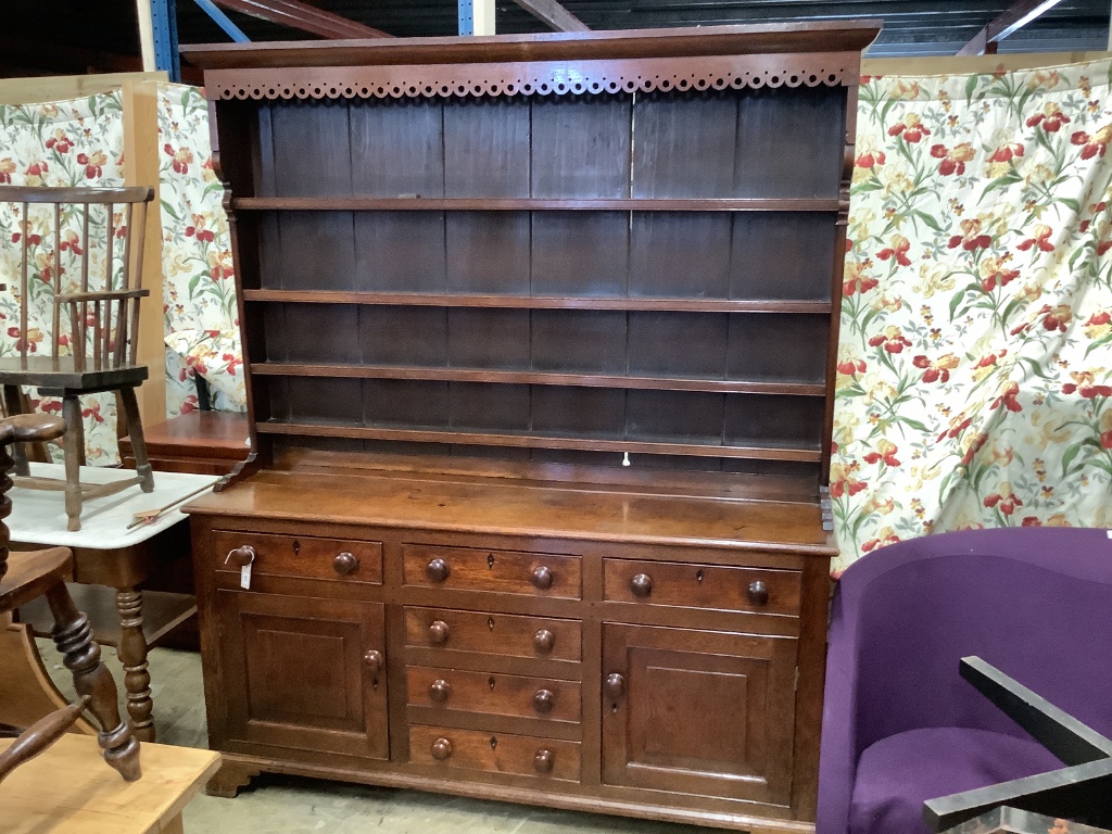 An early 19th century oak dresser with boarded rack, W-174, D-48, H-210cm.
